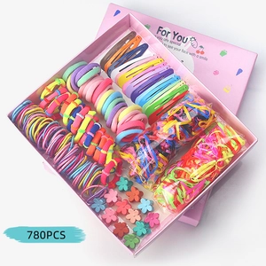 Flat lay of 780pcs colorful kids hair accessories set including clips and bands in gift box