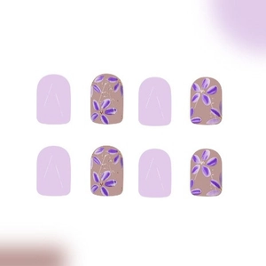 Purple floral press-on nails set with lavender hues and rhinestone accents on white base