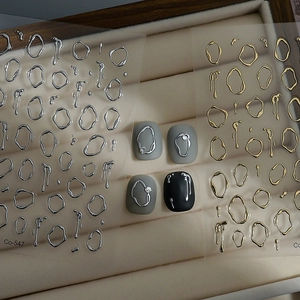 Macro detail of 3D liquid metal nail stickers in gold and silver finish Co-547
