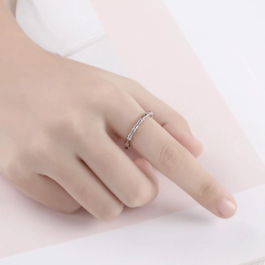 Minimalist silver bamboo joint ring detail showing segmented design on model finger