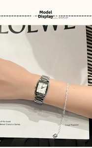 Detail of silver square quartz watch with steel band and matching beaded bracelet