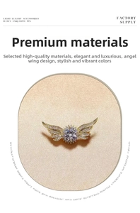 Detailed view of angel wing brooch with white cubic zirconia and gold-plated finish