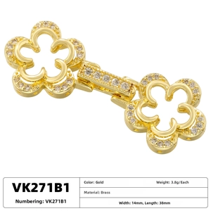Macro view of gold flower brass connector clasp with white cubic zirconia crystals