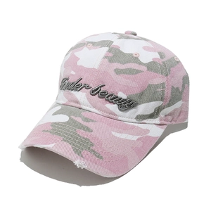 Close-up of pink camo baseball cap with Finder-Beauty embroidery and distressed brim