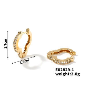 Macro shot showing 1.7cm x 1.9cm dimensions and zircon detail on gold heart earrings