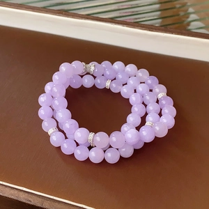 Detailed close-up of multi-layer lavender fluorite beads with silver zircon accents