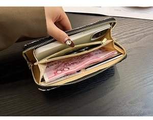Detail view of large capacity black zipper wallet showing multiple card slots and phone pocket