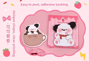 Close-up of cute dog-shaped sticky notes with Record the beauty text in a pink theme