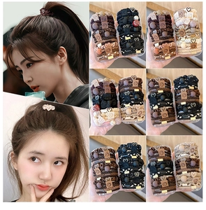 Detail of high-elasticity hair ties with cartoon charms and heart accents in neutral tones