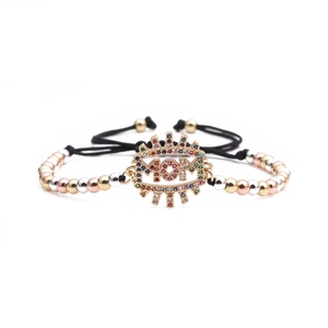 Macro detail of MOM bracelet featuring colorful zircons and adjustable black braided cord