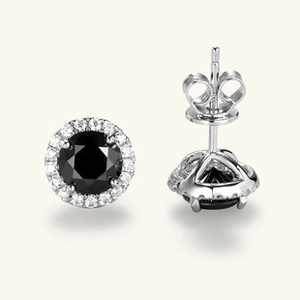 Macro view of silver stud earring with round black gemstone and halo setting details