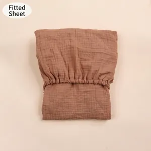 Close-up of a brown double-layer cotton gauze fitted sheet with a soft crinkle texture