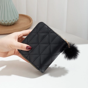 Quilted black faux leather wallet with pom-pom keychain and gold zipper closure