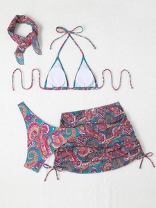 Flat lay of four-piece paisley print bikini set including skirt and headband