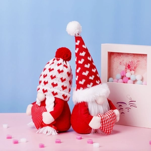 Pair of Valentine's Day gnomes in red and white knit hats with decorative hearts