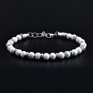 Detailed macro view of white stone beads with silver metal spacers and lobster clasp