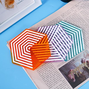 Detailed view of hexagonal resin coasters with geometric patterns and colorful glitter