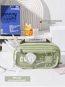 Detailed close-up of light green canvas pencil case with frosted frosted compartment