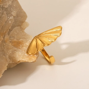 Elegant gold ginkgo leaf stainless steel open ring resting on a natural stone surface