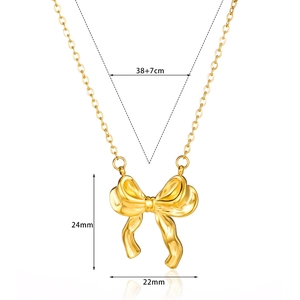 Detailed size view of a gold bow pendant necklace showing 38+7cm length and dimensions