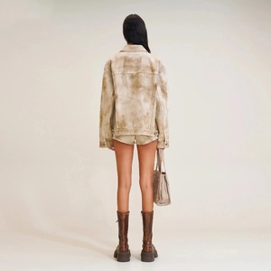 Rear view of vintage wash denim jacket set with leather mid-calf boots in earth tones