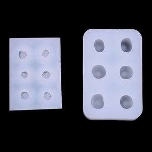 Macro view of white silicone cherry and berry molds with multiple cavities on black background