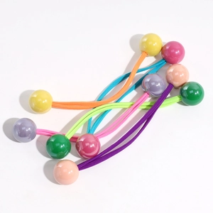 Close-up of five colorful elastic hair ties with smooth plastic beads in candy colors