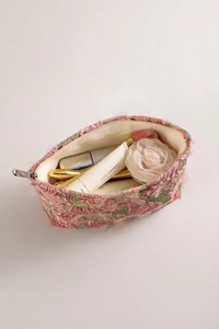 Detail of pink 3D flower makeup bag showing spacious interior and premium metal zipper