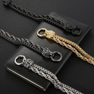 Detail of lion head braided bracelets in black, gold and silver on leather background