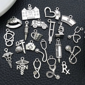 Silver vintage medical charms collection featuring stethoscope and syringe for DIY jewelry