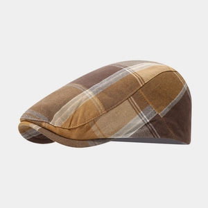 Vintage British plaid beret in brown and beige colors with classic flat cap silhouette