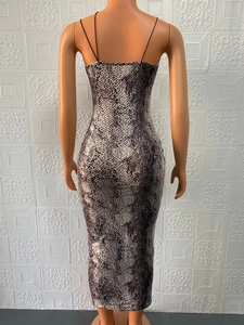 Rear view of a sleeveless bodycon midi dress with snakeskin pattern and thin straps