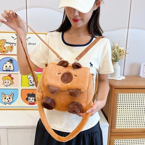 Cute brown plush Capybara crossbody bag with adjustable strap worn by a model