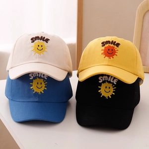 Detail of kids baseball caps featuring smile embroidery and vibrant sun patterns