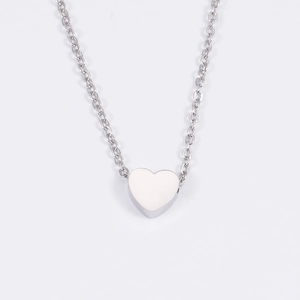 Polished silver heart pendant necklace in stainless steel on a white background