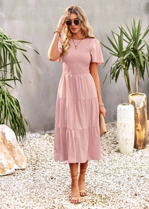 Close-up of pink smocked bodice and multi-layered cake skirt for summer vacation