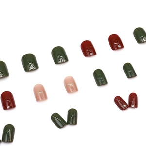 Short square Christmas press-on nails in deep green, red, and pink with glitter stripes