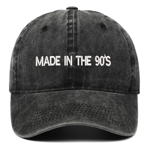 Close-up of MADE IN THE 90'S white embroidery on dark gray washed cotton baseball cap