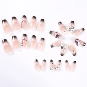Detail of nude pink nails with black gradient, 3D pink hearts and crystal butterflies