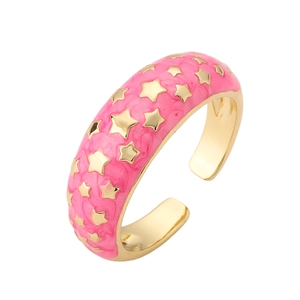 Detail of pink enamel open ring featuring gold stars and polished metallic inner band