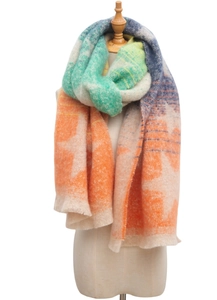 Close-up of soft gradient boucle yarn scarf with colorful blue and orange star jacquard