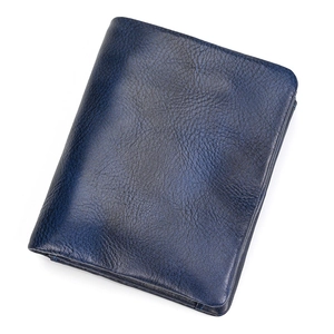 Detail of premium navy blue leather wallet showing natural grain texture and fold