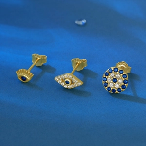 Detailed close-up of three gold S925 sterling silver evil eye stud earrings with blue zircon