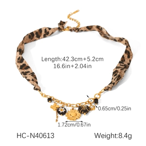 Leopard print fabric necklace with gold sunflower pendants and dimension details