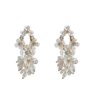 Macro shot of white jasmine flower earrings with gold finish and sparkling crystal center