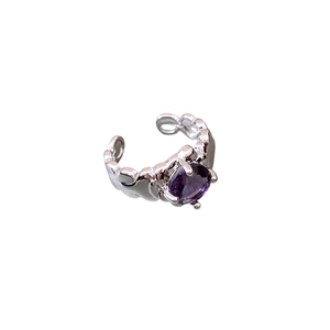 Vintage silver crumpled ring with a round purple gemstone center in 45-degree view