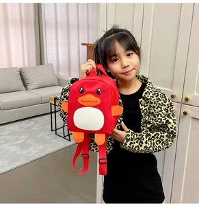 Close-up of red penguin toddler backpack made of nylon material on a model