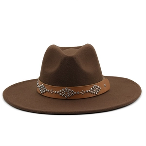 Detail of dark brown wool fedora hat featuring a studded leather band with silver rivets