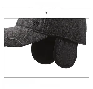 Detail view of winter earflap baseball cap featuring thick dark grey woolen texture