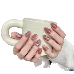 Short oval cat eye press-on nails in rose red with white floral art and glossy finish